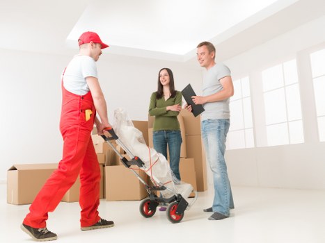 Mover wearing PPE while carrying furniture